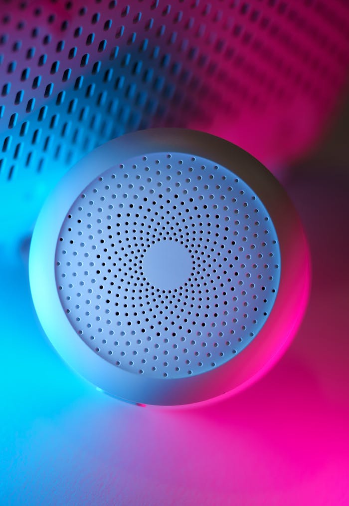 Modern smart home device with vibrant neon blue and pink lighting, showcasing advanced design.